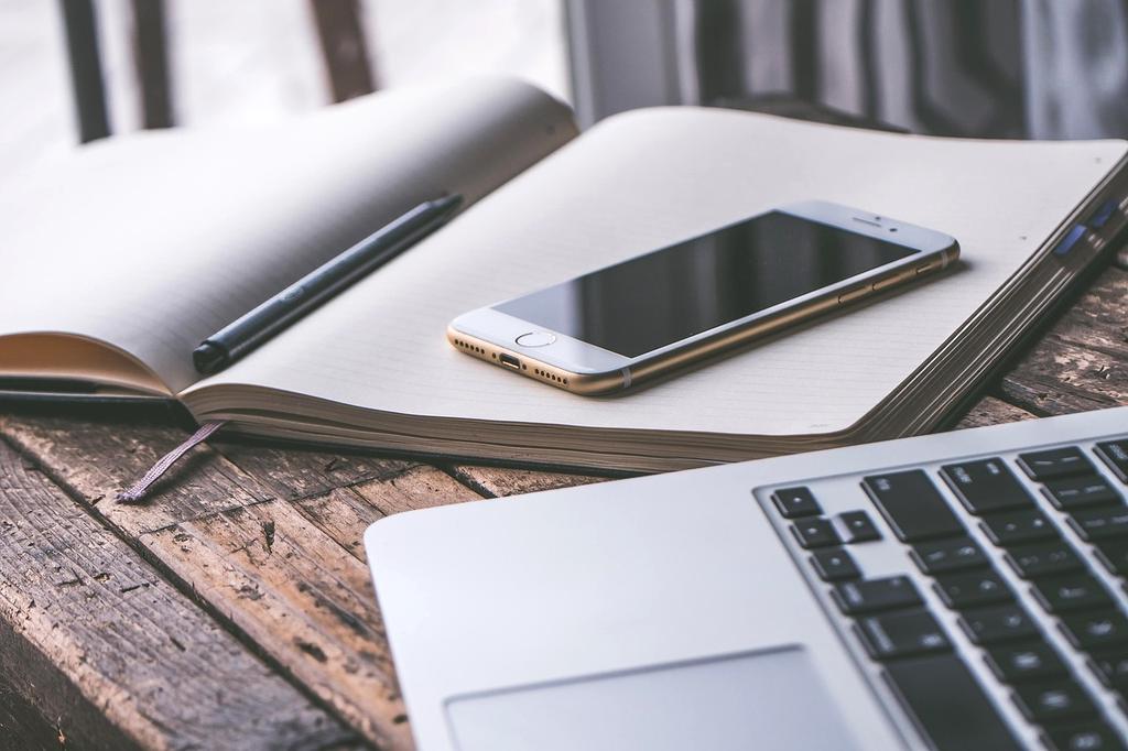 Contact illustration showing a person at a desk with communication devices